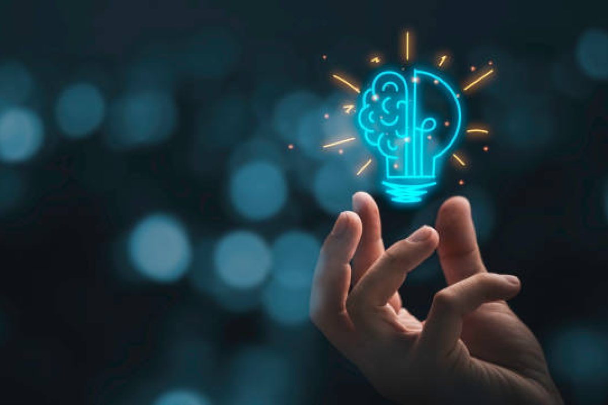 Hand holding drawing virtual lightbulb with brain on bokeh background for creative and smart thinking idea concep